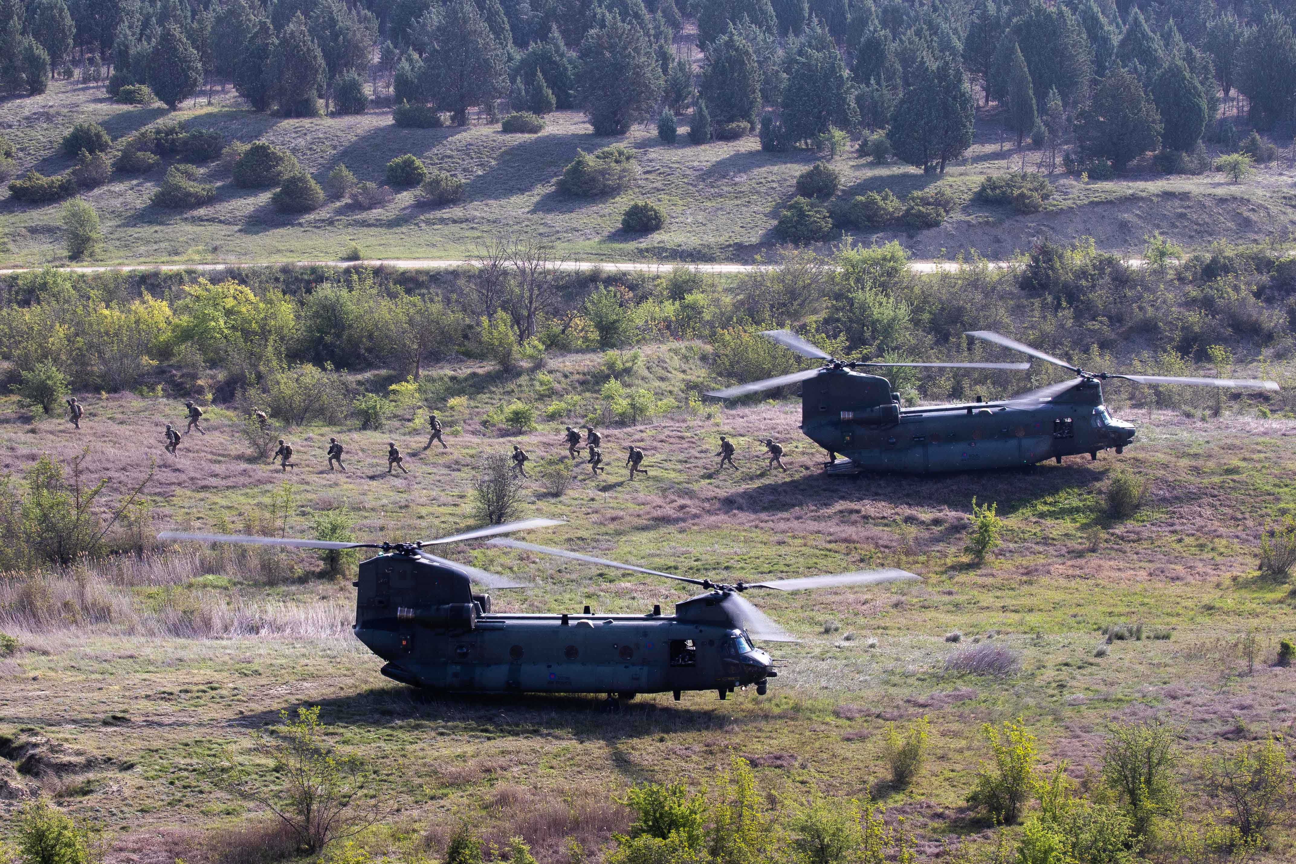 Helicopters on the ground with personnel.